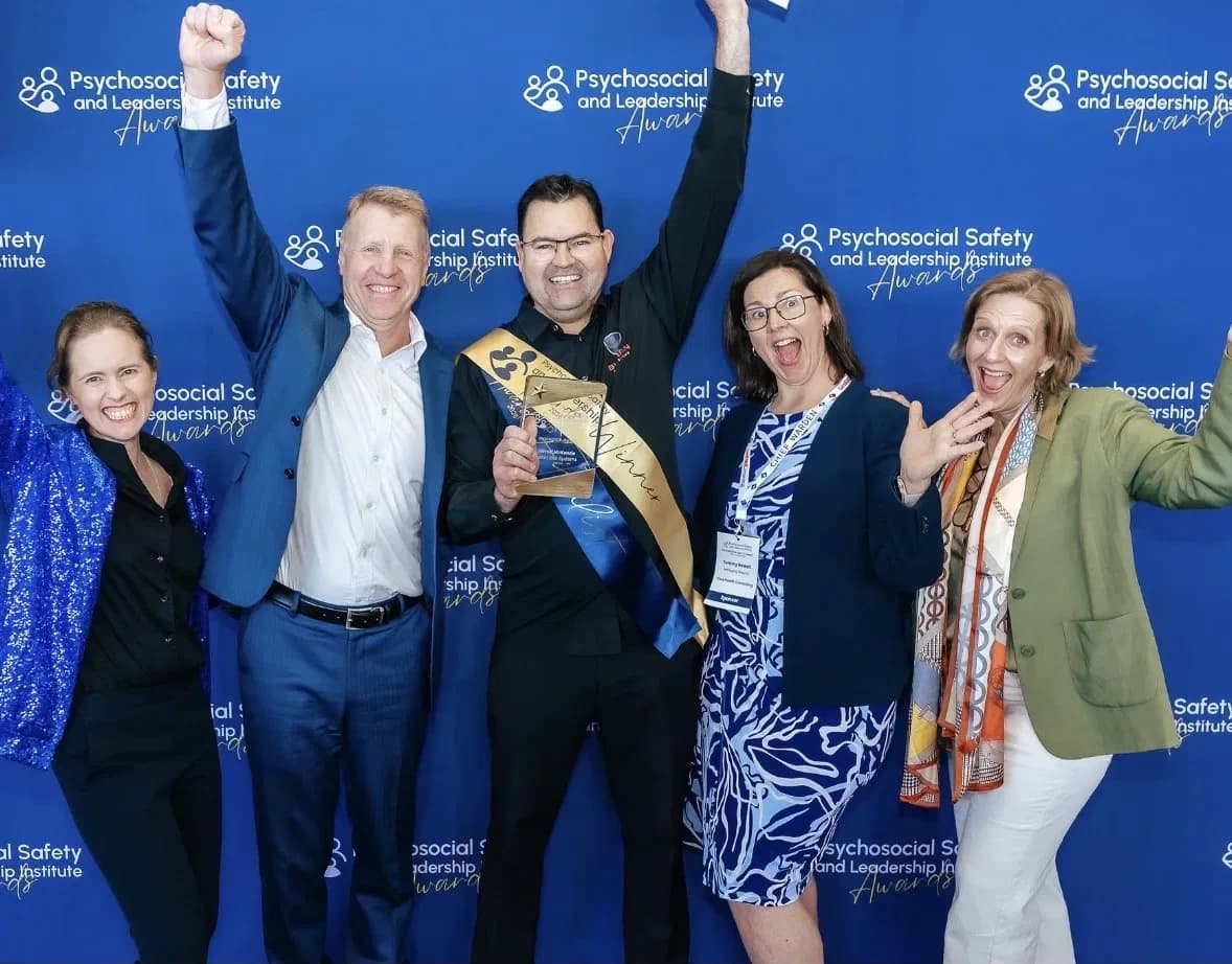 Jarrod McKenzie holding the Innovation in Psychosocial Risk Management trophy at the 2026 Psychosocial Safety and Leadership Institute Awards, Tweed Heads.